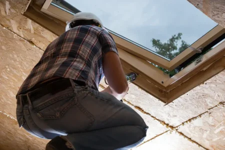 low-angle-view-male-construction-worker-builder-applying-fresh-caulking-sky-light-ceiling-unfinished-home