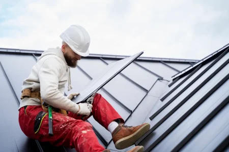 man-with-helmet-working-roof-full-shot