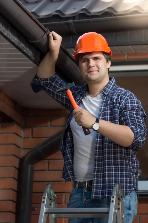 portrait-handsome-worker-hardhat-posing-with-hammer-step-ladder