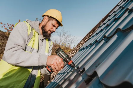 sideways-man-working-roof-with-drill